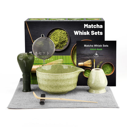 Matcha whisk set with bowl, whisk, and other tools on a gray mat with packaging in the background.
